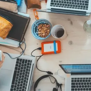 A bunch of laptops on a table from above