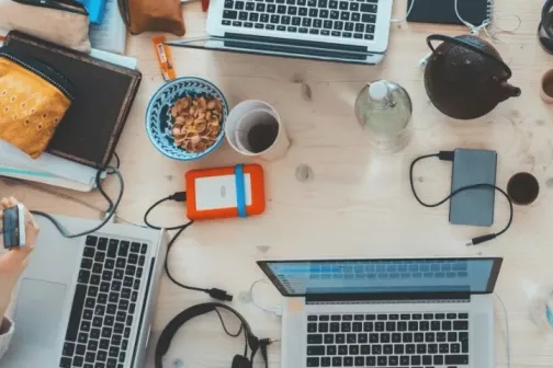 A bunch of laptops on a table from above